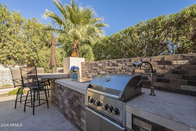 view of patio / terrace with area for grilling and an outdoor bar