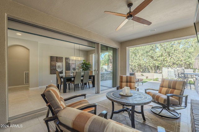 sunroom featuring ceiling fan