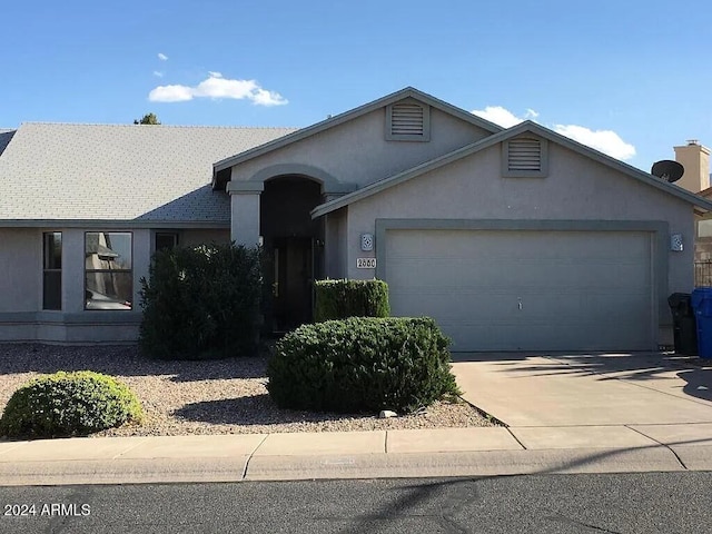 ranch-style home featuring a garage