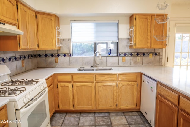 kitchen featuring decorative light fixtures, white appliances, tasteful backsplash, and sink