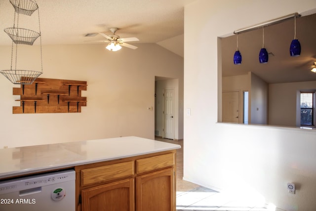 kitchen featuring ceiling fan, dishwasher, hanging light fixtures, a textured ceiling, and lofted ceiling