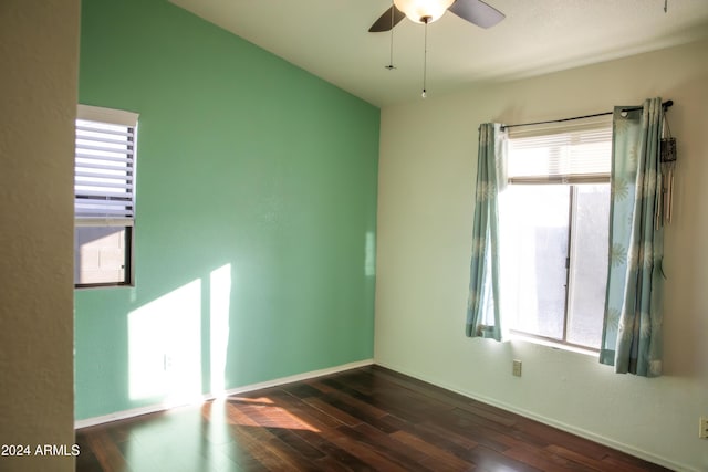 empty room featuring dark hardwood / wood-style flooring, ceiling fan, and a healthy amount of sunlight