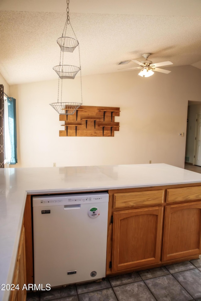 kitchen featuring ceiling fan, dishwasher, hanging light fixtures, and a textured ceiling