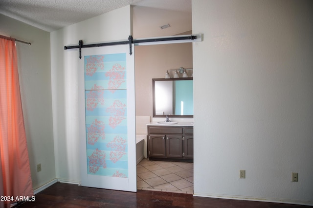 bathroom featuring tile patterned flooring, a textured ceiling, and vanity