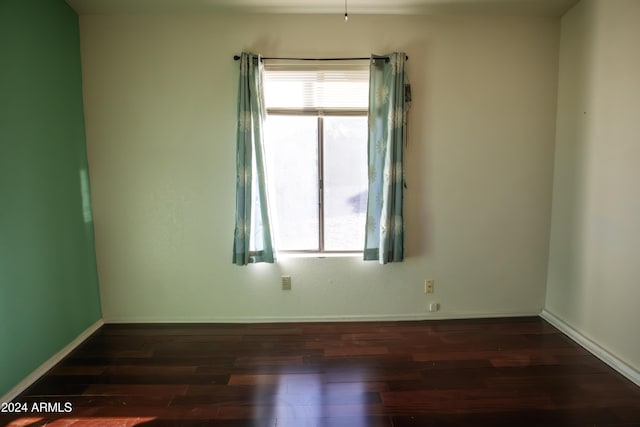 spare room with dark hardwood / wood-style floors