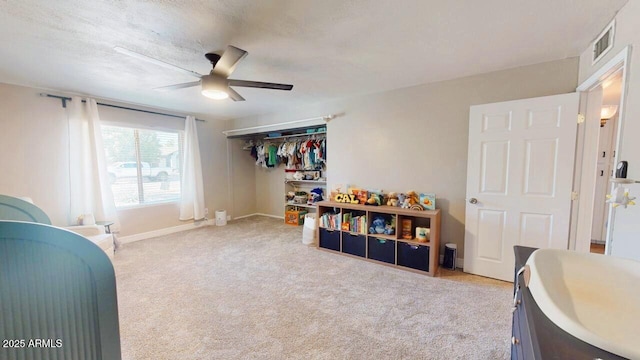 bedroom featuring ceiling fan, carpet floors, visible vents, baseboards, and a closet