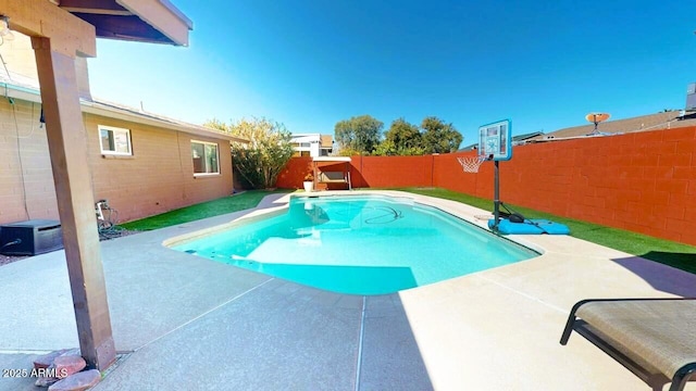 view of swimming pool featuring a patio area, a fenced backyard, and a fenced in pool