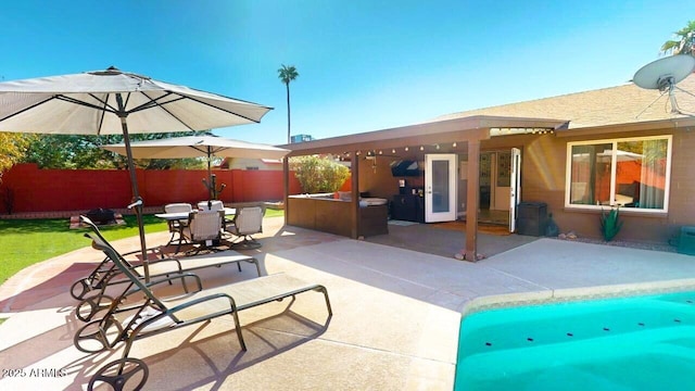 view of patio featuring outdoor dining space and fence