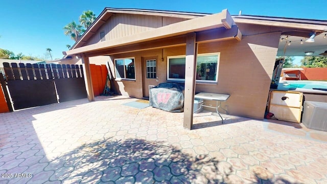 back of house featuring a patio area and fence