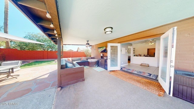 view of patio with outdoor lounge area and fence