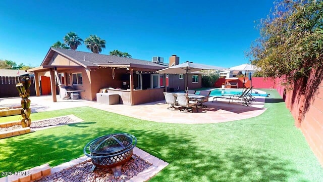 back of house featuring an outdoor fire pit, a patio, a fenced backyard, cooling unit, and a yard