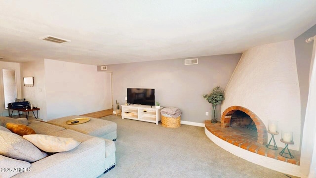 carpeted living area featuring baseboards, a fireplace, and visible vents