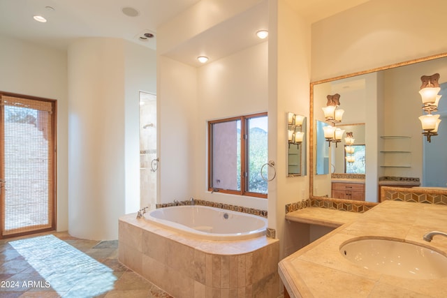 bathroom with a healthy amount of sunlight, tile flooring, and vanity