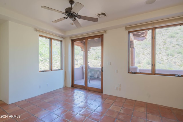 empty room with tile flooring and ceiling fan