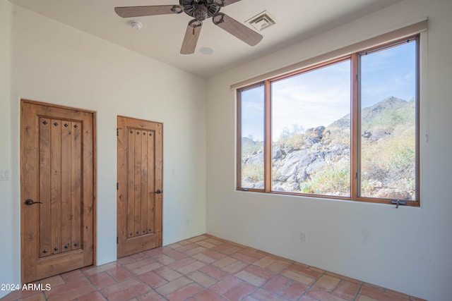 unfurnished bedroom with ceiling fan and tile flooring