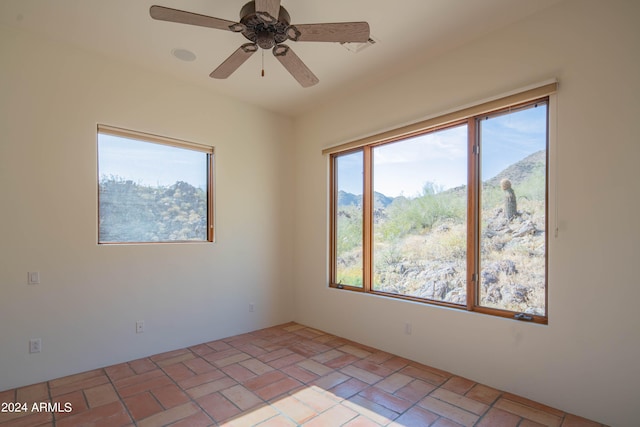 tiled empty room with ceiling fan