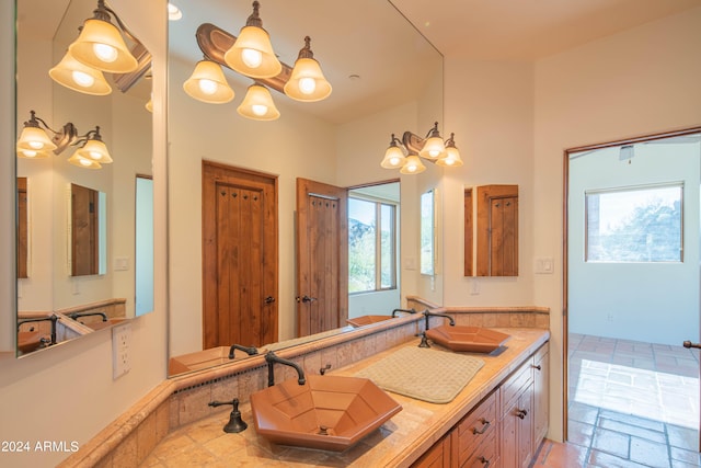 bathroom with large vanity, a notable chandelier, and tile flooring