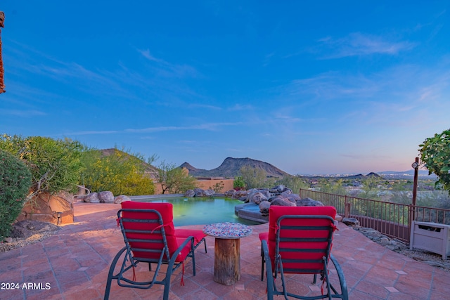 view of patio / terrace featuring a swimming pool and a mountain view