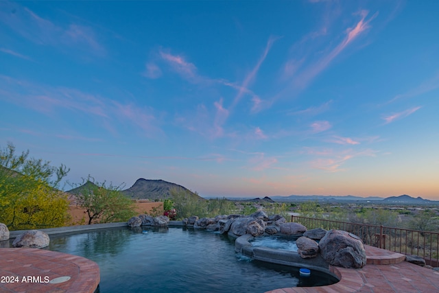 pool at dusk with a mountain view