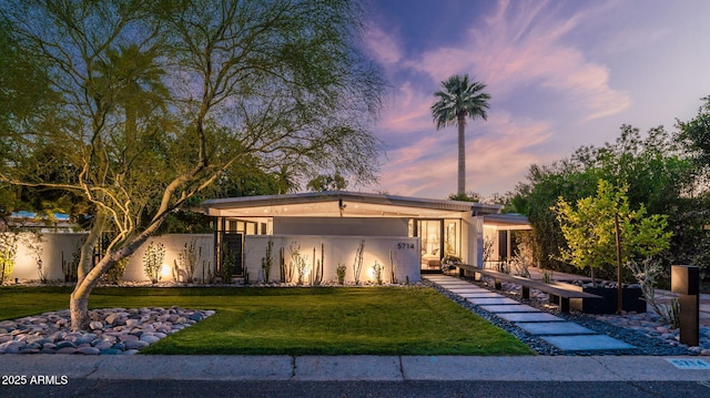 5714 N 11th St, Phoenix, AZ 85014 - mid-century home with a yard, stucco siding, and an attached carport