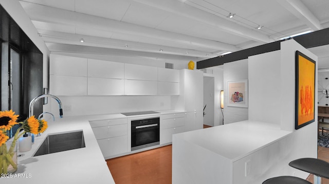 5714 N 11th St, Phoenix, AZ 85014 - kitchen featuring black appliances, modern cabinets, a sink, light countertops, and beamed ceiling
