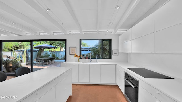 5714 N 11th St, Phoenix, AZ 85014 - kitchen featuring black appliances, modern cabinets, light countertops, white cabinets, and a sink