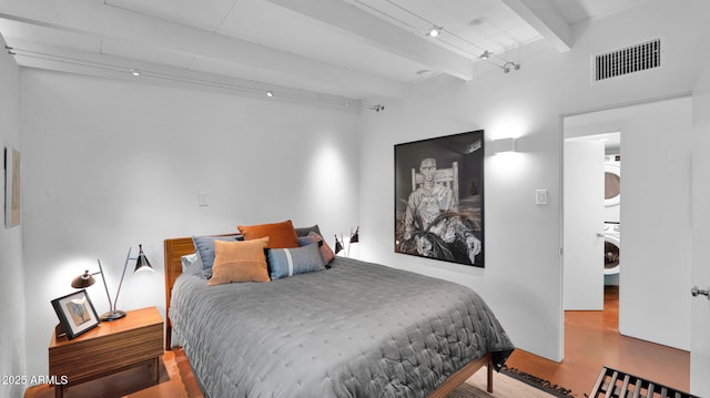 5714 N 11th St, Phoenix, AZ 85014 - bedroom with estacked washer and dryer and beamed ceiling