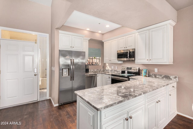 kitchen with light stone countertops, stainless steel appliances, dark hardwood / wood-style flooring, and white cabinetry