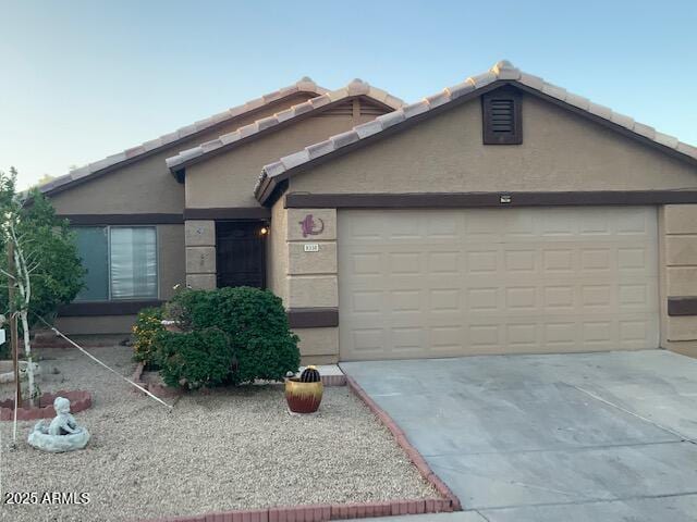 8338 W Coolidge St, Phoenix, AZ 85037 - ranch-style house with driveway, an attached garage, and stucco siding