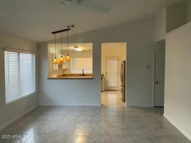 8338 W Coolidge St, Phoenix, AZ 85037 - spare room with vaulted ceiling, baseboards, and light tile patterned flooring