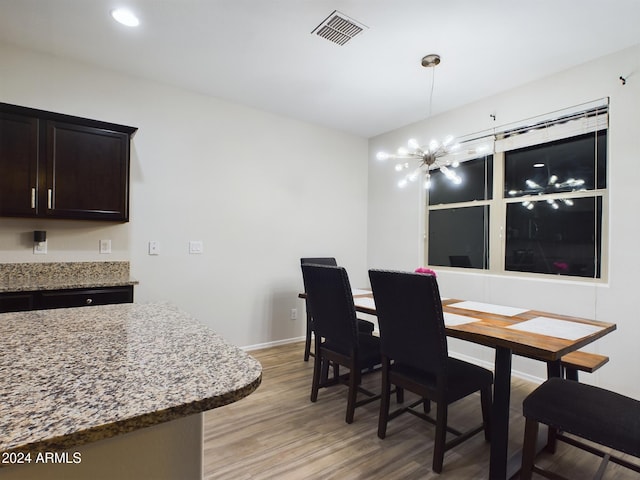 dining area with a chandelier and light hardwood / wood-style floors