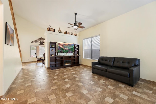 living room featuring ceiling fan and high vaulted ceiling