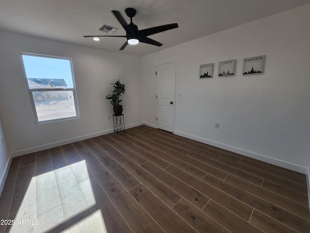 empty room with ceiling fan and dark wood-type flooring