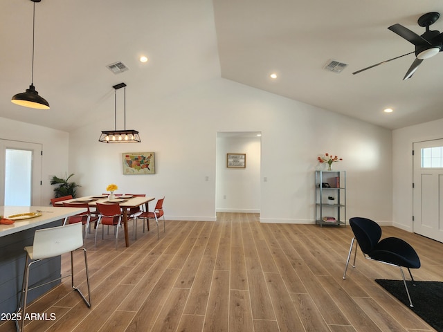 interior space featuring ceiling fan, vaulted ceiling, and light wood-type flooring