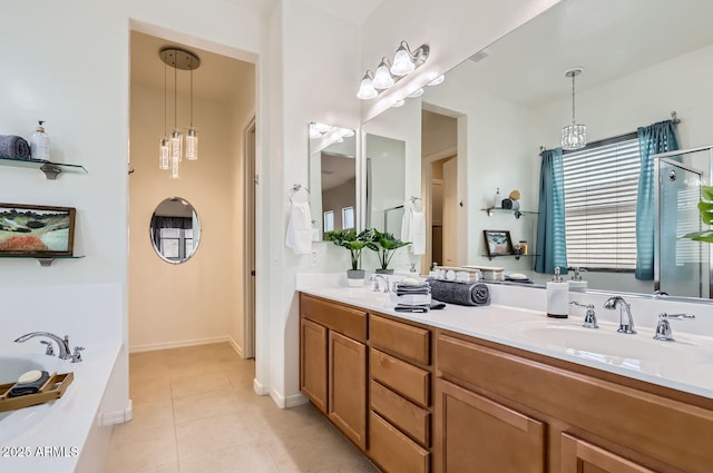 bathroom with tile patterned floors, a bathtub, and vanity