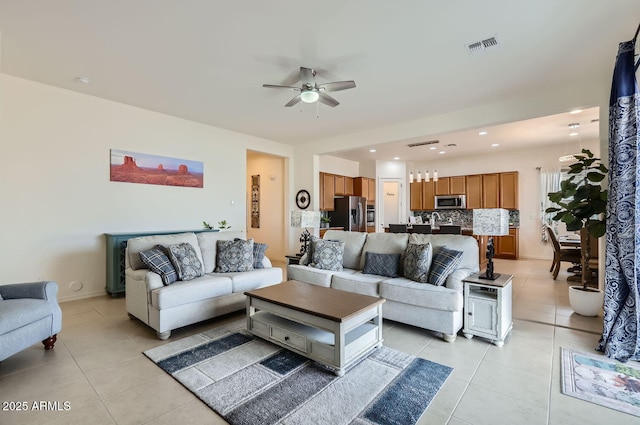 tiled living room featuring ceiling fan