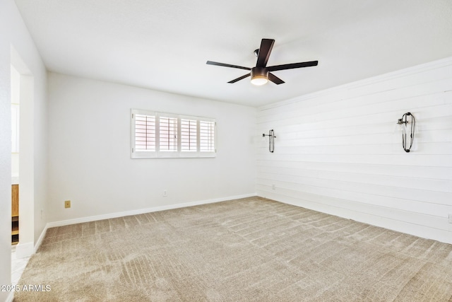 unfurnished room with ceiling fan, carpet, and baseboards