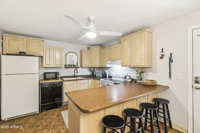 kitchen featuring a peninsula, under cabinet range hood, black appliances, light brown cabinets, and a sink