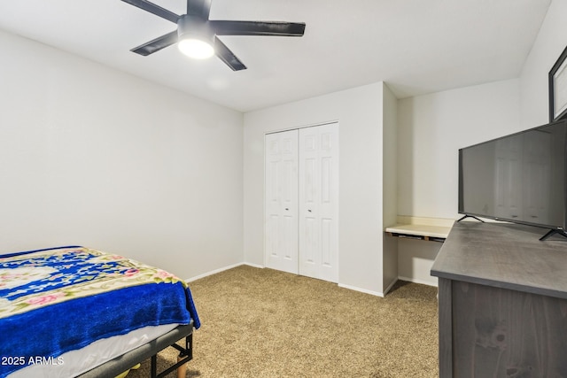 bedroom with a ceiling fan, a closet, light carpet, and baseboards