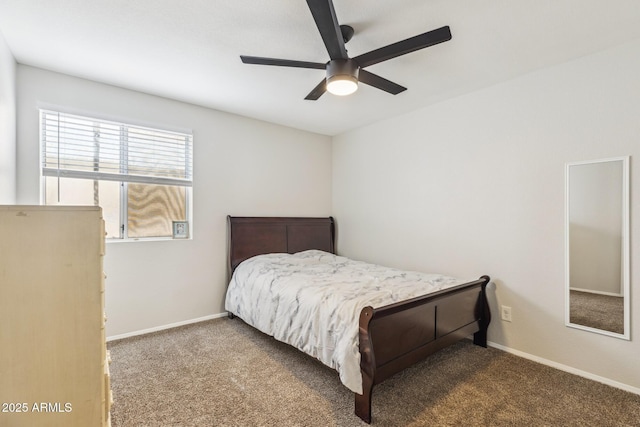 carpeted bedroom with ceiling fan and baseboards