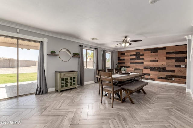 23332 N Serenity Trl, Florence, AZ 85132 - dining room with wooden walls, ceiling fan, ornamental molding, and an accent wall
