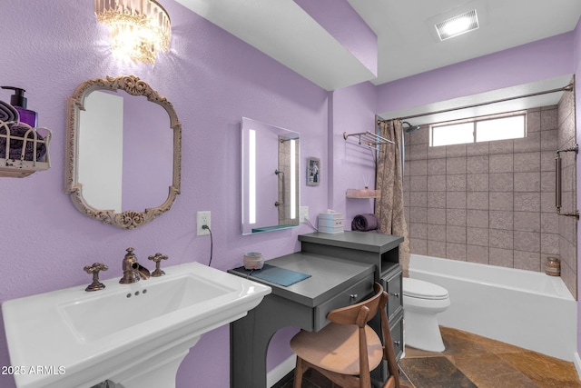 bathroom featuring a sink, visible vents, toilet, and shower / tub combo