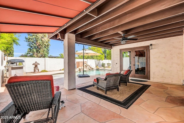 view of patio / terrace with french doors, a fenced backyard, a fenced in pool, and a ceiling fan