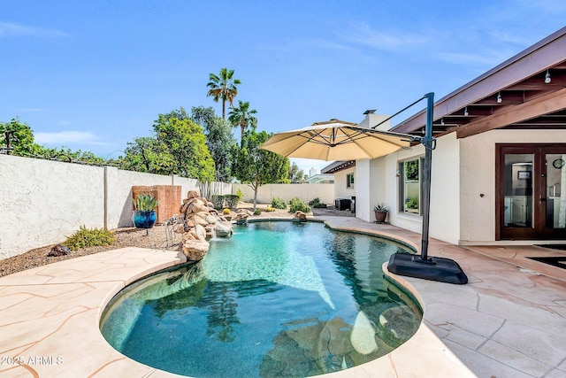 view of pool featuring a fenced backyard, a fenced in pool, and a patio
