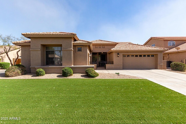 mediterranean / spanish house featuring an attached garage, a front yard, concrete driveway, and stucco siding