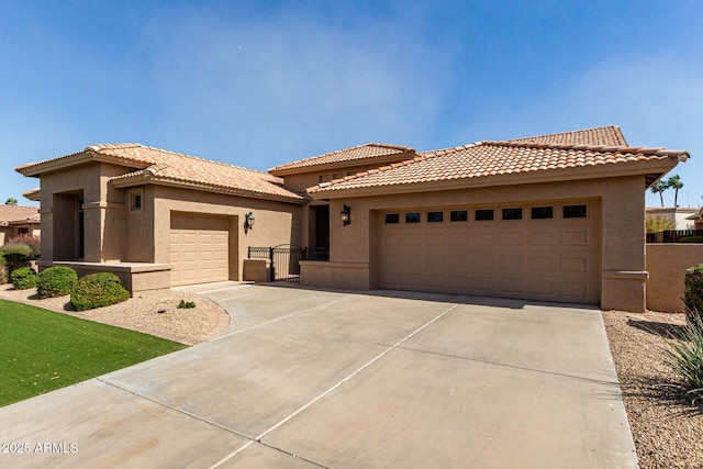 view of front of home featuring a garage, concrete driveway, and stucco siding