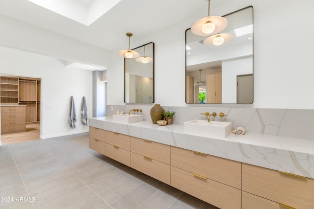 bathroom featuring vanity, tasteful backsplash, and tile patterned floors