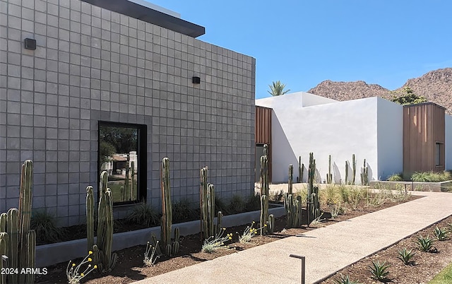 view of side of home with a mountain view