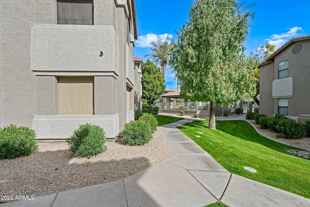 view of property's community featuring a yard and a gazebo