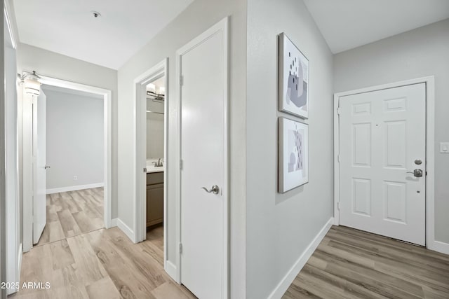 hall featuring sink and light wood-type flooring